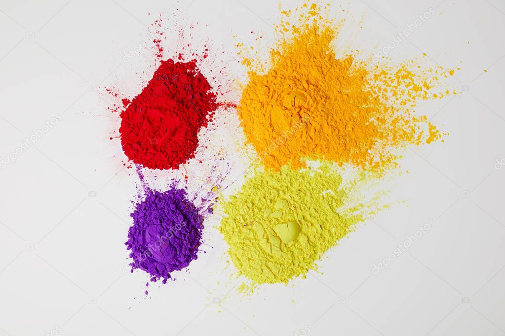 top view of four colors of holi powder for Hindu spring festival,  isolated on white