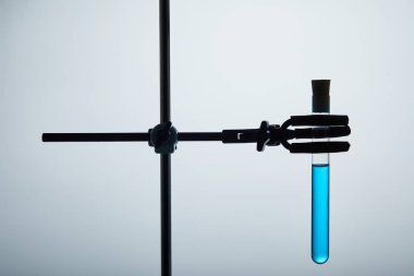 test tube filled with blue liquid on chemistry stand clipart