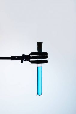 test tube filled with blue liquid on stand clipart