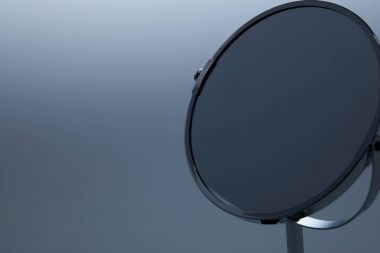 close-up shot of makeup mirror with stand on grey clipart