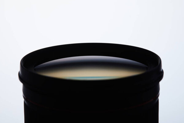 close-up shot of camera lens silhouette on white