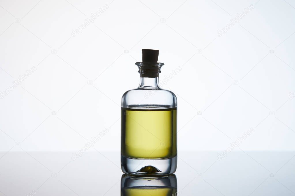 closed bottle of aromatic massage oil on white