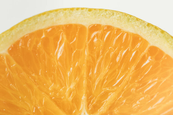 Close-up view of ripe orange fruit flesh isolated on white background