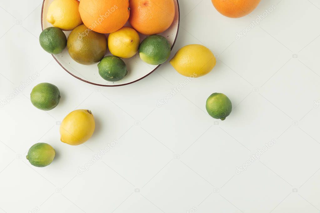 Juicy citruses on plate isolated on white background