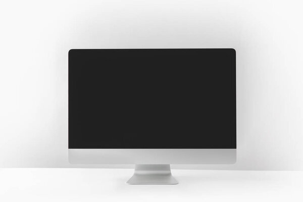 modern desktop computer with black screen on white
