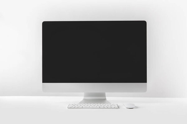 modern desktop computer with blank screen on white