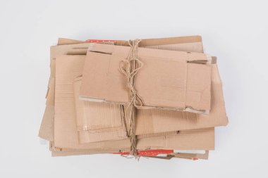 top view of pile of folded cardboard boxes isolated on grey, recycle concept clipart