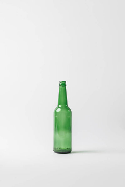close up view of empty glass bottle isolated on grey, recycling concept