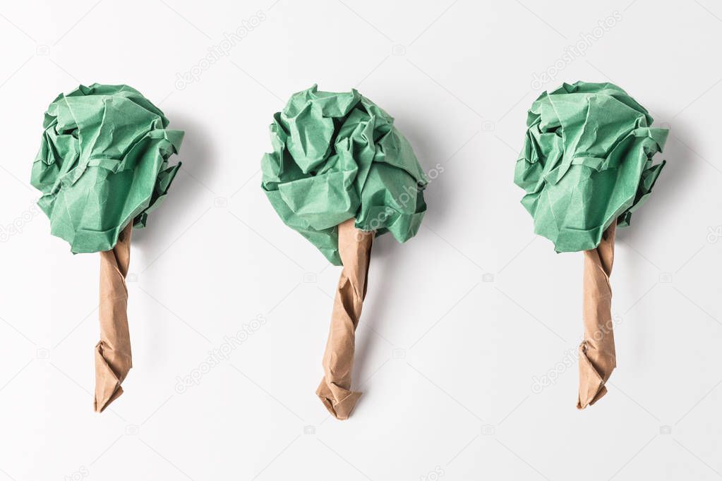 top view of paper made green trees isolated on grey, recycling and environment protection concept
