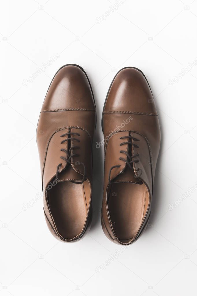 top view of pair of grooms shoes isolated on white