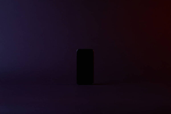 top view of one black smartphone on dark