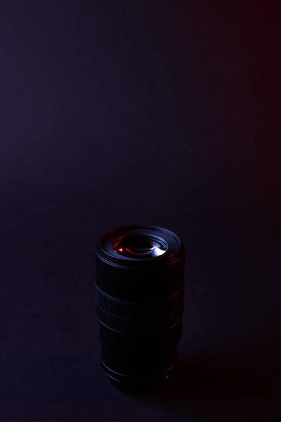 one photographic objective on dark surface