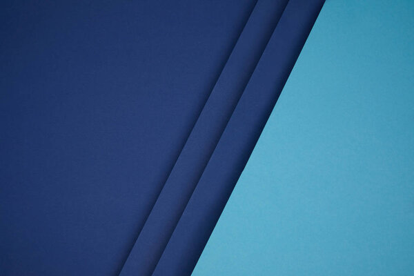 dark and bright blue geometric paper background 
