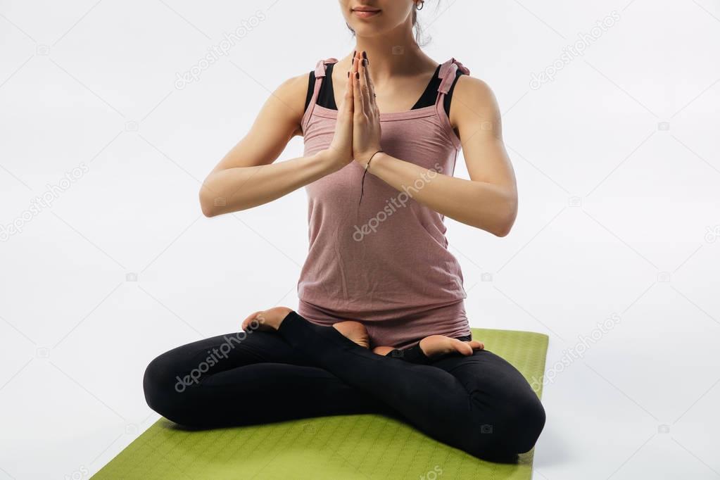 cropped image of woman practicing yoga and sitting in padmasana 