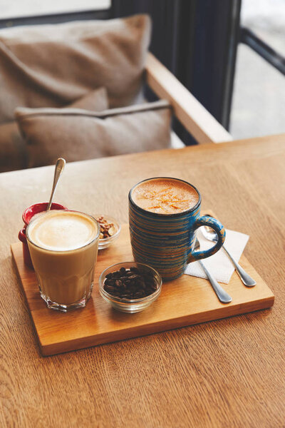 Coffee beverages with milk on cafe table