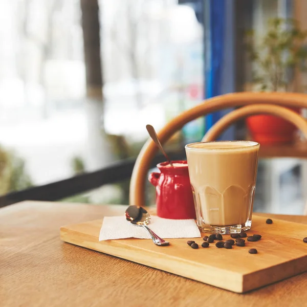 Hot flat white coffee in glass on table