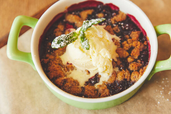 Crumble served in pot with ice cream