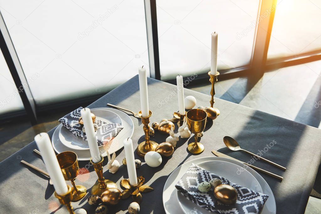 high angle view of decorated easter table with sunlight