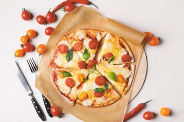 top view of appetizing tasty homemade pizza and cherry tomatoes on white clipart