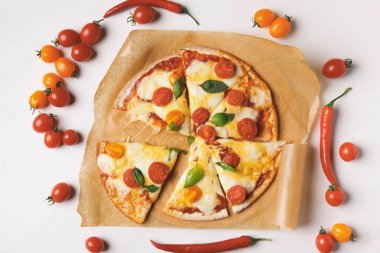top view of appetizing tasty homemade pizza on white table clipart