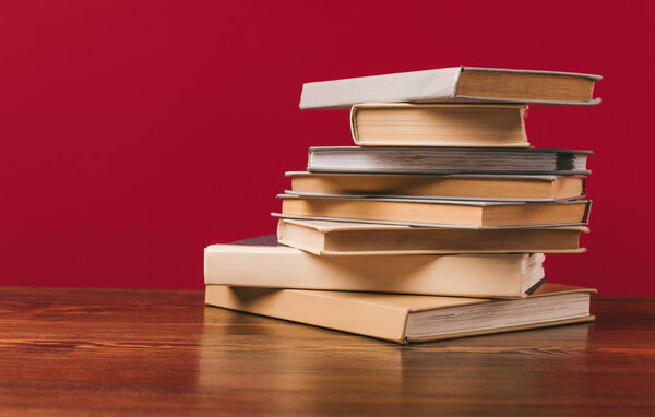 Floor with stack of different books on red