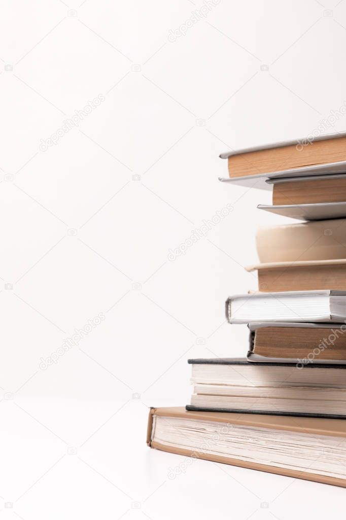 Partial view of stack of different books isolated on white 