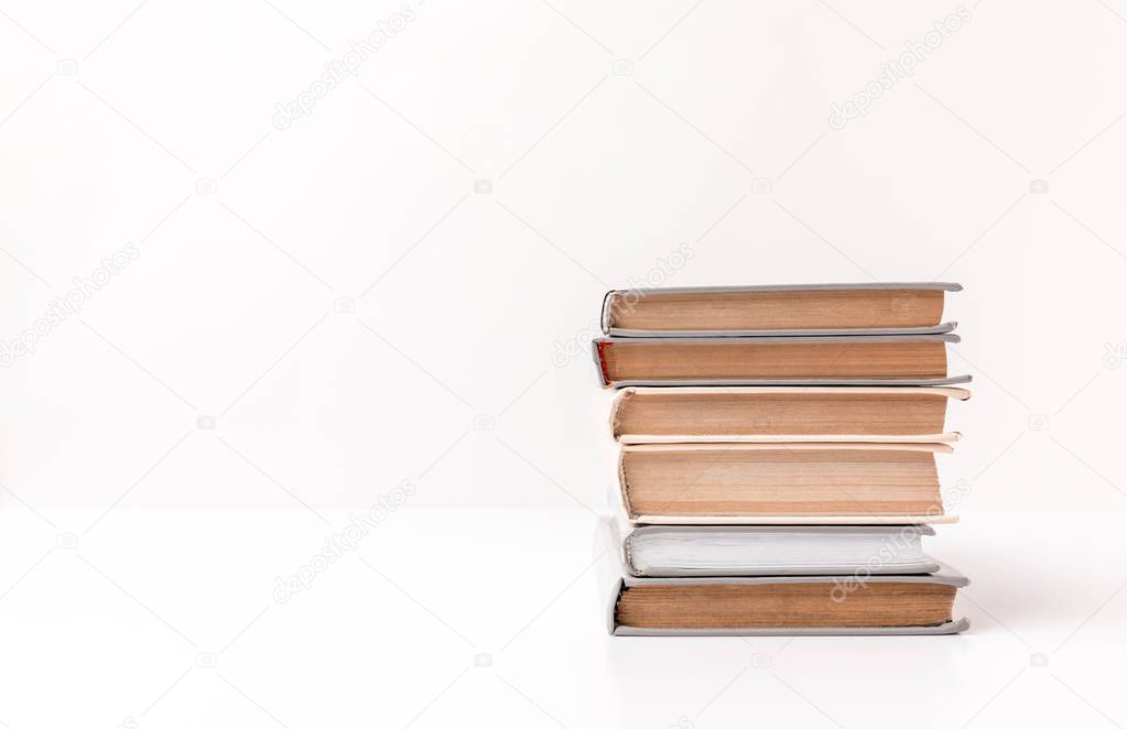 Stack of different books isolated on white