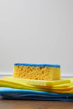yellow and blue rags and washing sponge for spring cleaning clipart