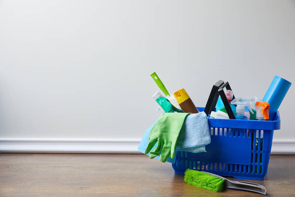 domestic supplies for spring cleaning in basket on floor