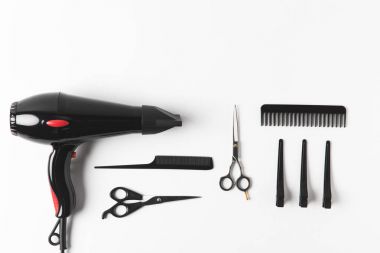 flat lay with hairdryer and hairdressing tools, on white