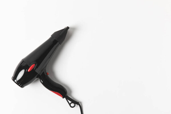 top view of black hair dryer, on white background