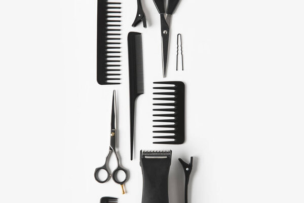 flat lay with hair clipper and hairdressing tools, on white
