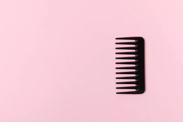 One Black Comb Isolated Light Pink — Stock Photo, Image