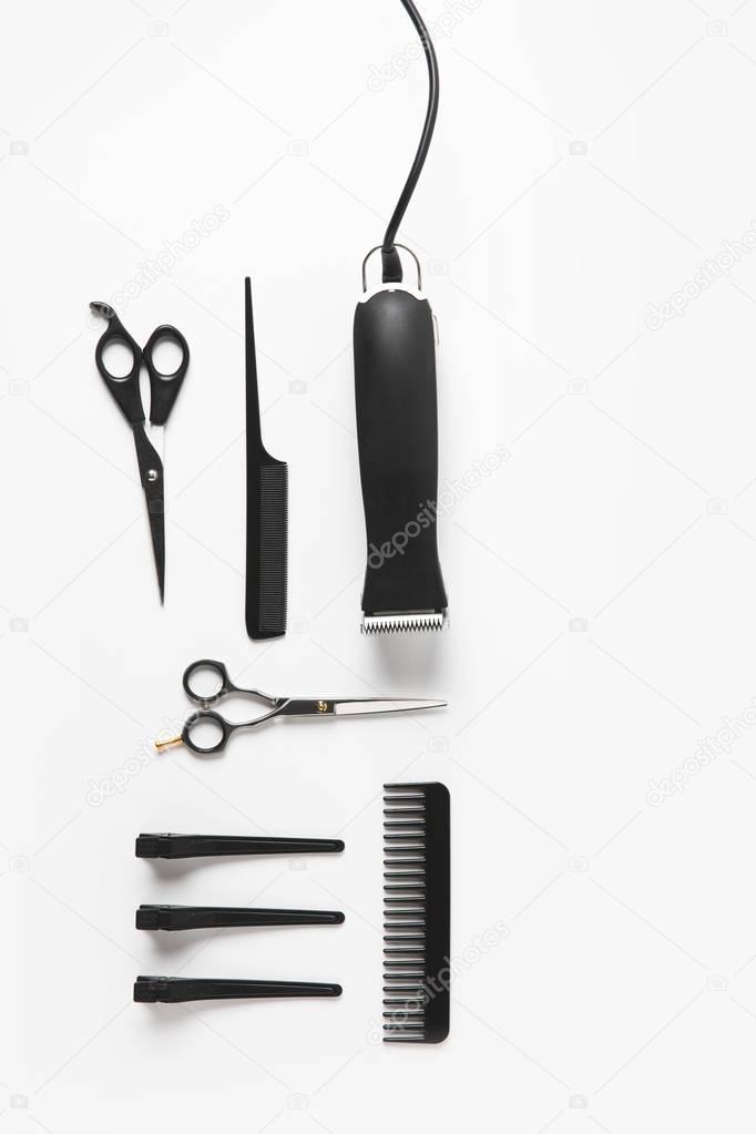 flat lay with hair clipper and hairdressing equipment, isolated on white