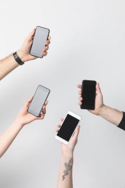 akıllı telefonlar üzerinde beyaz izole boş ekranlarla birlikte grup insan kısmi görünümünü