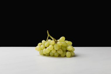 Close up view of pile of white grapes on black clipart