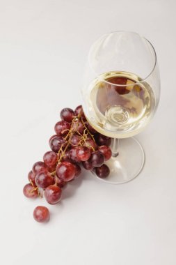 Top view of white wine glass and grapes on white clipart