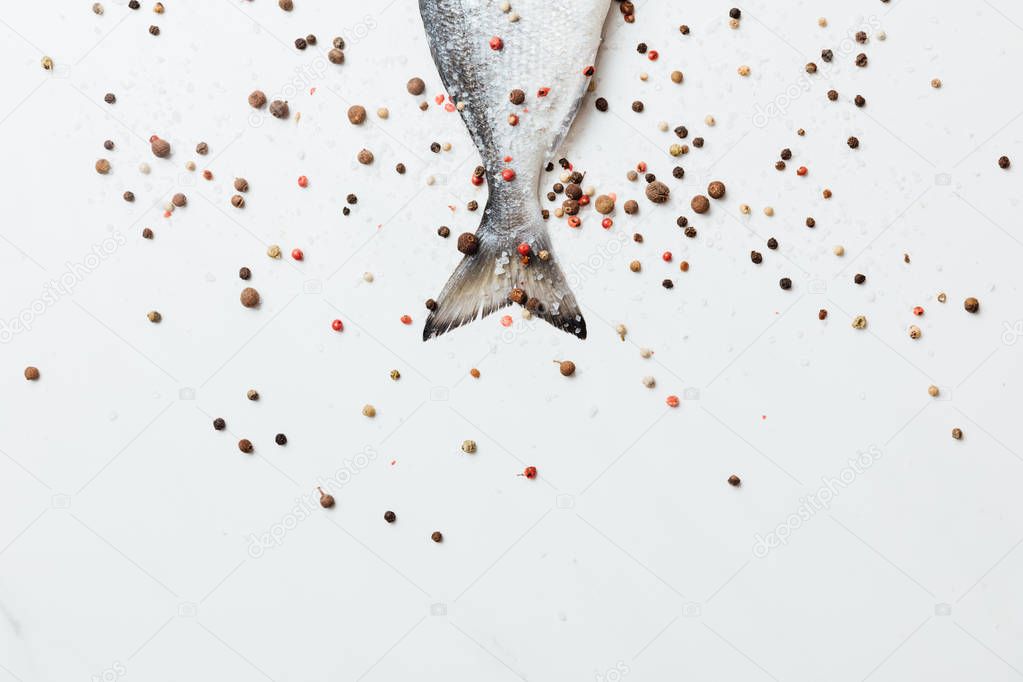 Sea fish seasoned with pepper and salt isolated on white