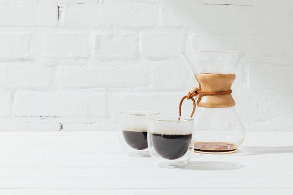 Two glass mugs with alternative coffee and chemex 