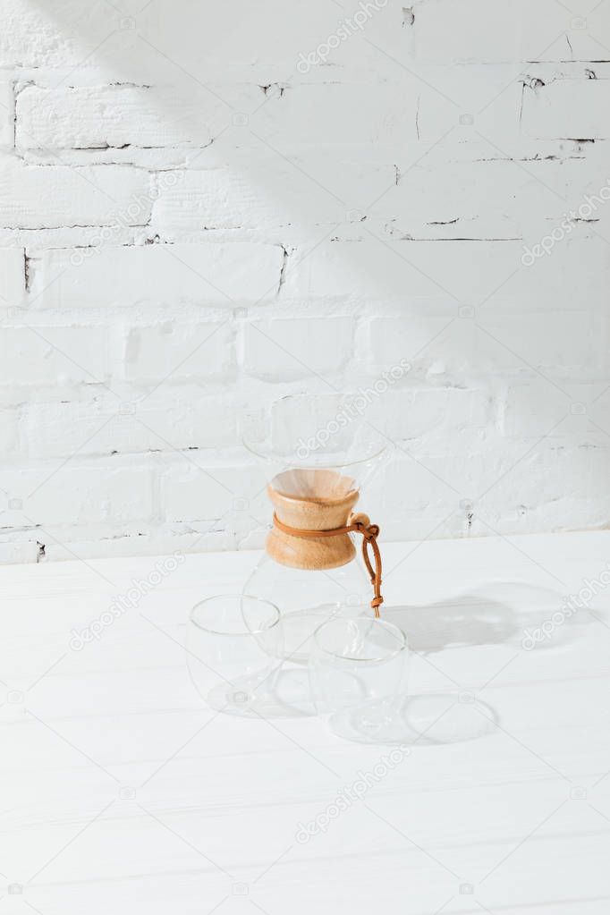 High angle view of empty glass mugs and chemex 