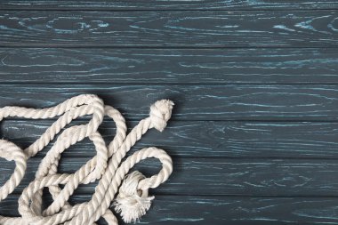 top view of knotted white nautical rope on wooden planks clipart