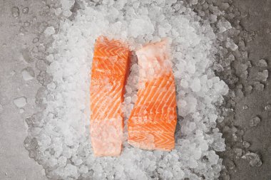 top view of slices of salmon on crushed ice clipart