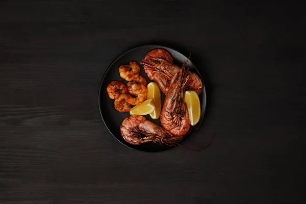 Top View Grilled Shrimps Lemon Pieces Plate Black Surface — Stock Photo, Image