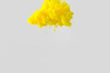 close up view of bright yellow paint splash in water isolated on gray clipart