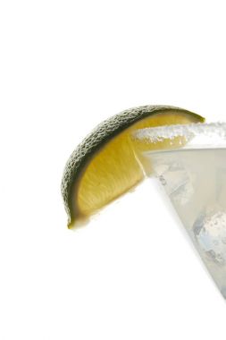 close up view of alcohol margarita cocktail with lime piece and ice isolated on white clipart