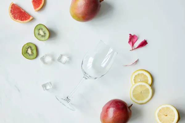 Flat Lay Empty Wineglass Flower Petals Ice Cubes Assorted Exotic — Stock Photo, Image