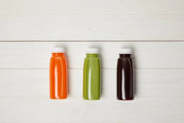 Top View Bottles Detox Smoothies Row Wooden Background — Stock Photo, Image