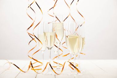 champagne glasses with ribbons on white wooden table, holiday concept  clipart