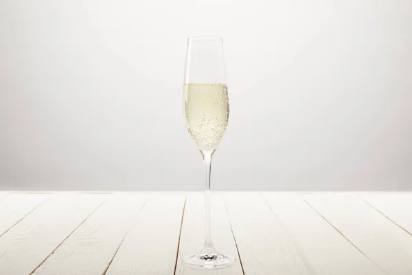 Closeup View Champagne Glass Bubbles White Wooden Table — Stock Photo, Image