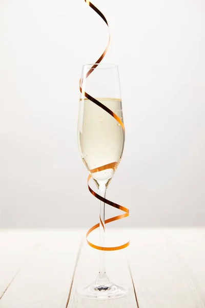 Närbild Bild Champagneglas Insvept Serpentin Vita Träbord Holiday Koncept — Gratis stockfoto